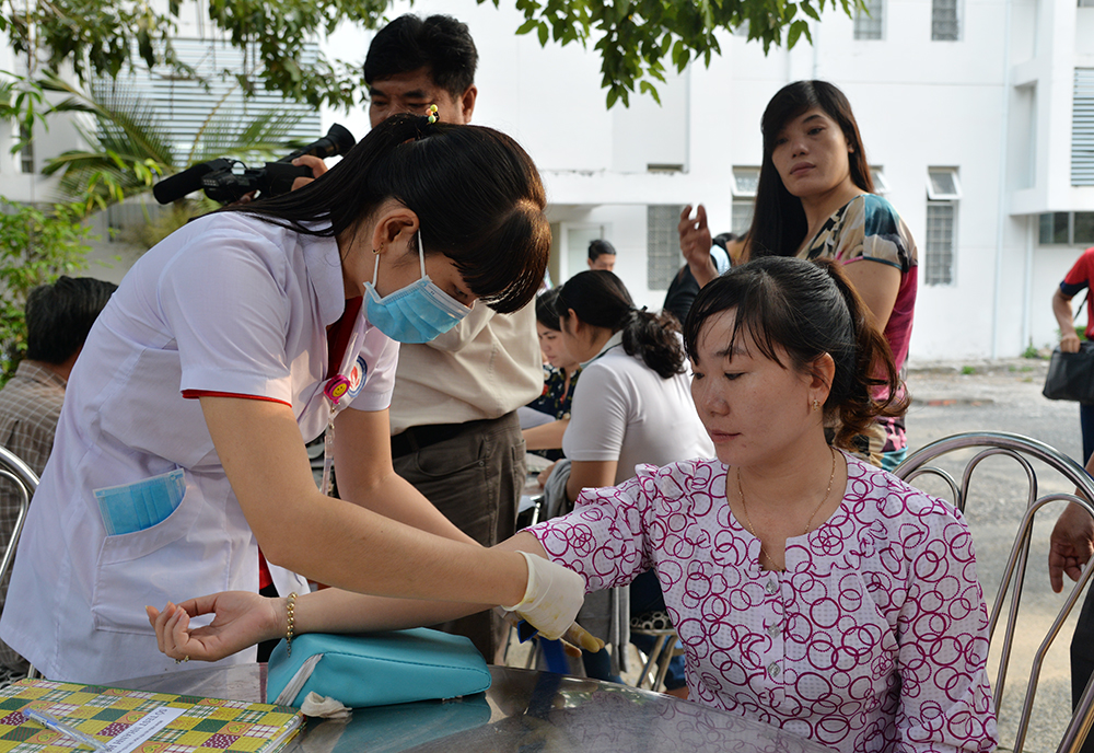 Cán bộ y tế kiểm tra sức khỏe người dân trước khi hiến máu